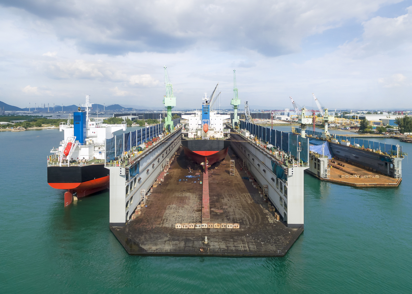 container ship repair in shipyard near warehouse at sea.